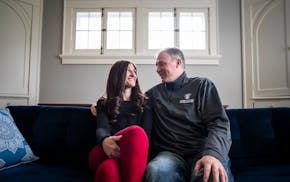 St. Thomas men’s basketball coach Johnny Tauer and his wife Chancey posed for a portrait in their St. Paul home.