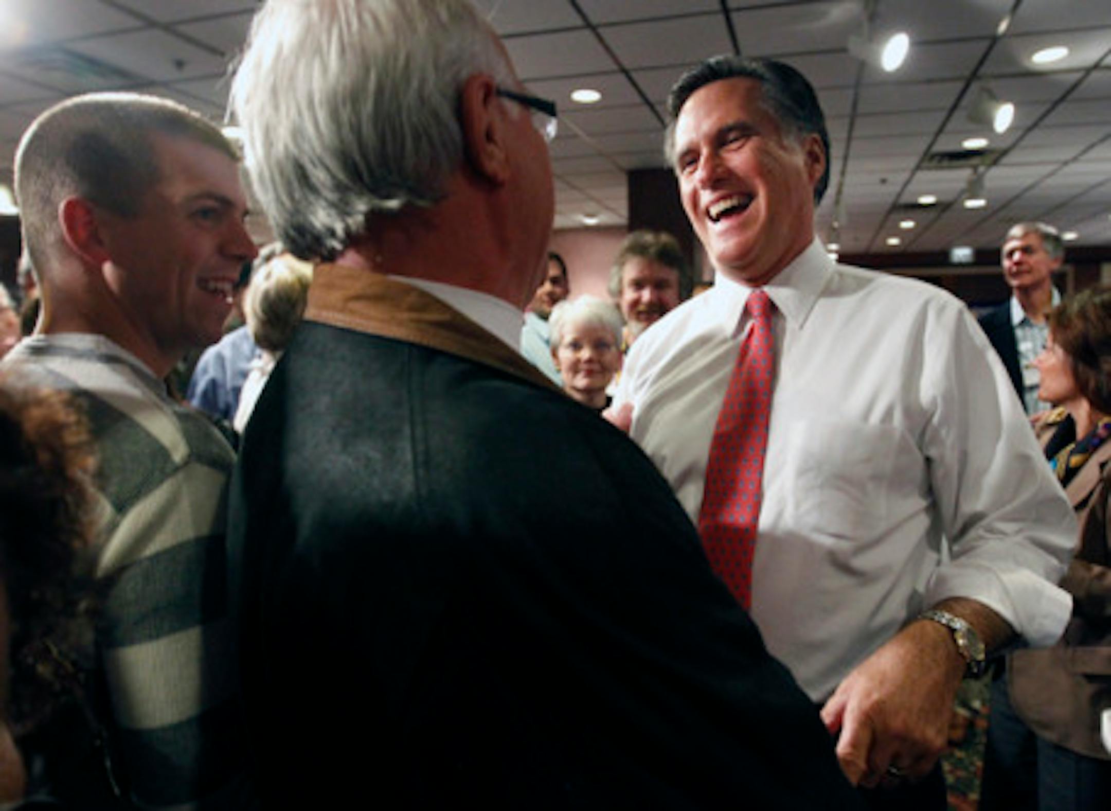 Mitt Romney with a fan at a Monday Bloomington rally/Rich Tsong-Taatarii