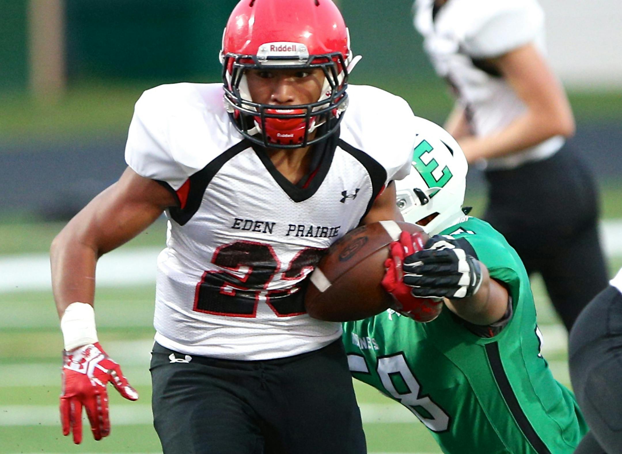 Eden Prairie running back Solo Falaniko breaks free from an Edina defenderís grasp for a nice gain for the Eagles in their 21-9 victory at Edina. Photo by Brian W Nelson SportsEngine