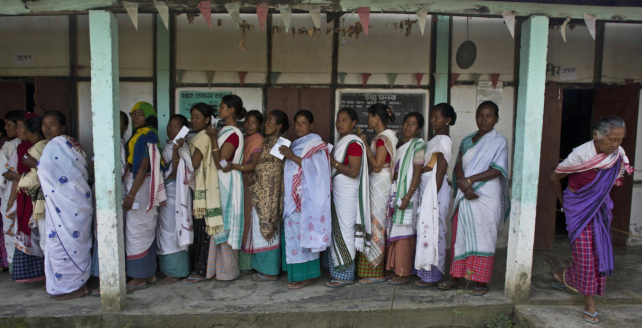 An elderly Indian Mishing tribal woman, right, leaves after casting her vote at a polling booth during the first phase of general elections in Majuli, in the eastern Indian state of Assam, Thursday, April 11, 2019. With 900 million of India's 1.3 billion people registered to vote, it is the world's largest democratic exercise. (AP Photo/Anupam Nath)