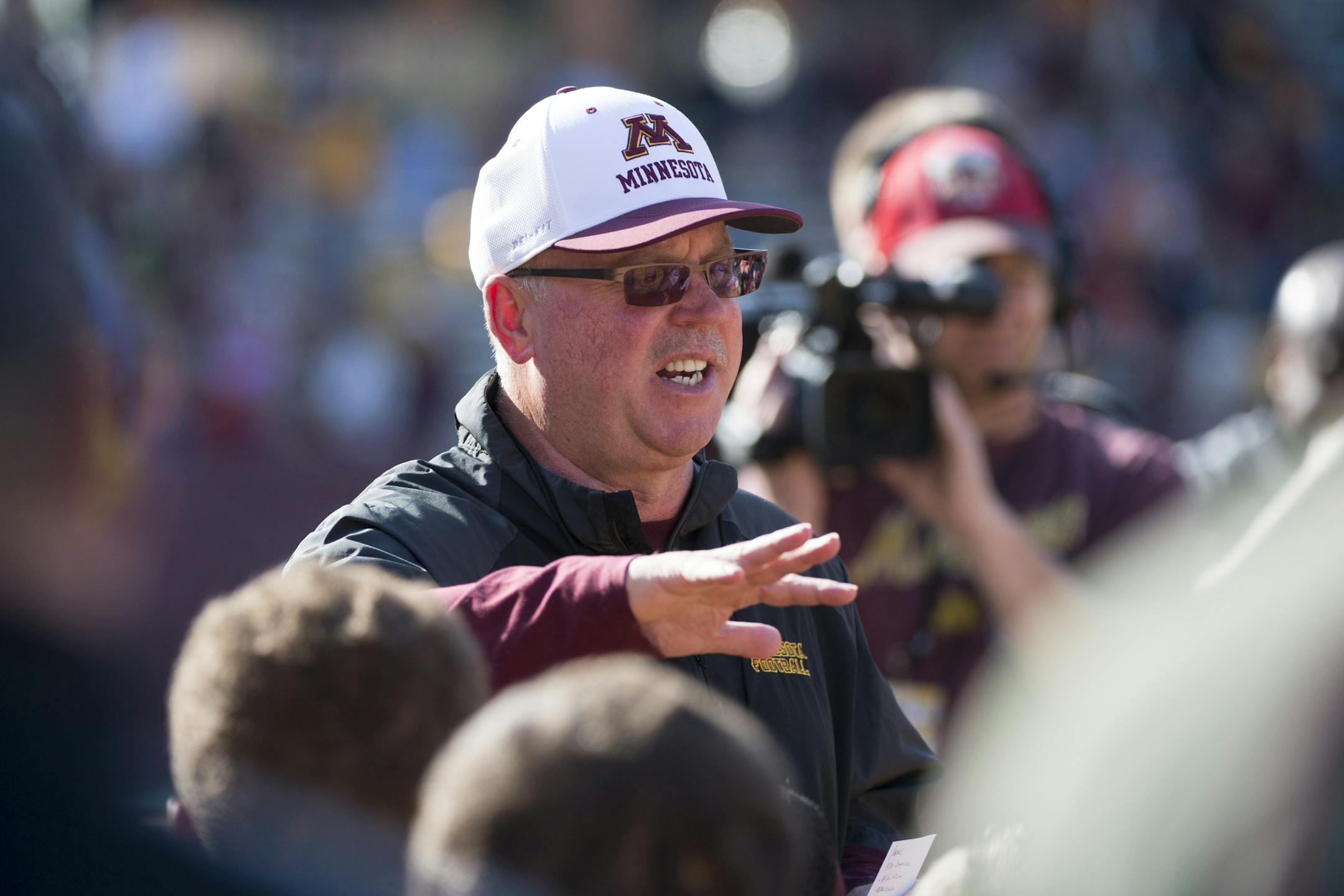 Jerry Kill talks to the team after the annual spring game.