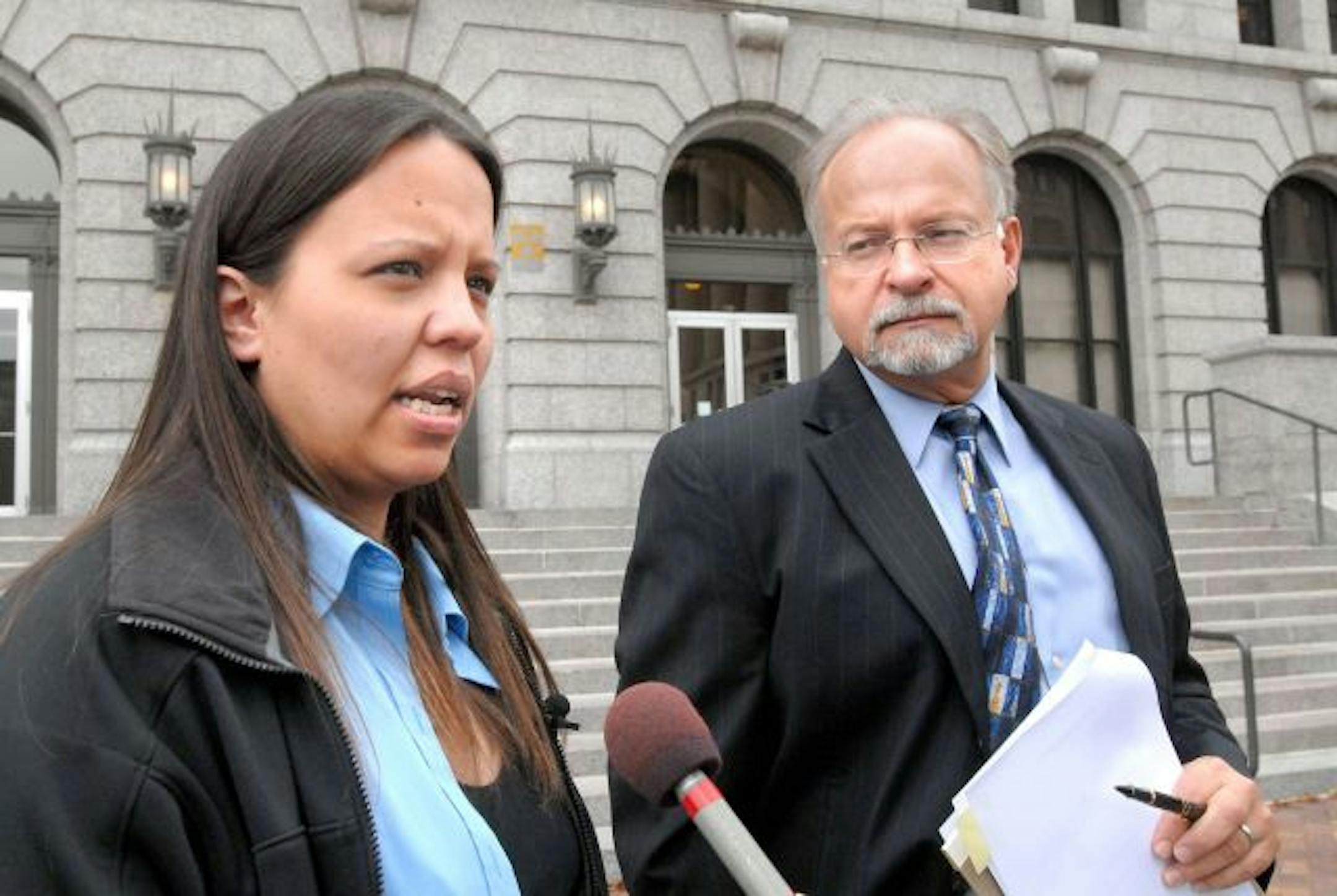 Jammie Thomas, left, who accused by the recording industry of sharing music online in violation of copyrights, with her lawyer Brian Toder, talk outside the Federal Courthouse in Duluth, Minn., Tuesday, Oct. 2, 2007. Thomas, a 30-year-old mother of two, is the first of 26,000 people sued by the industry whose case has gone to trial. An industry group and three recording companies claim she illegally offered 1,702 songs for free on a file-sharing network.