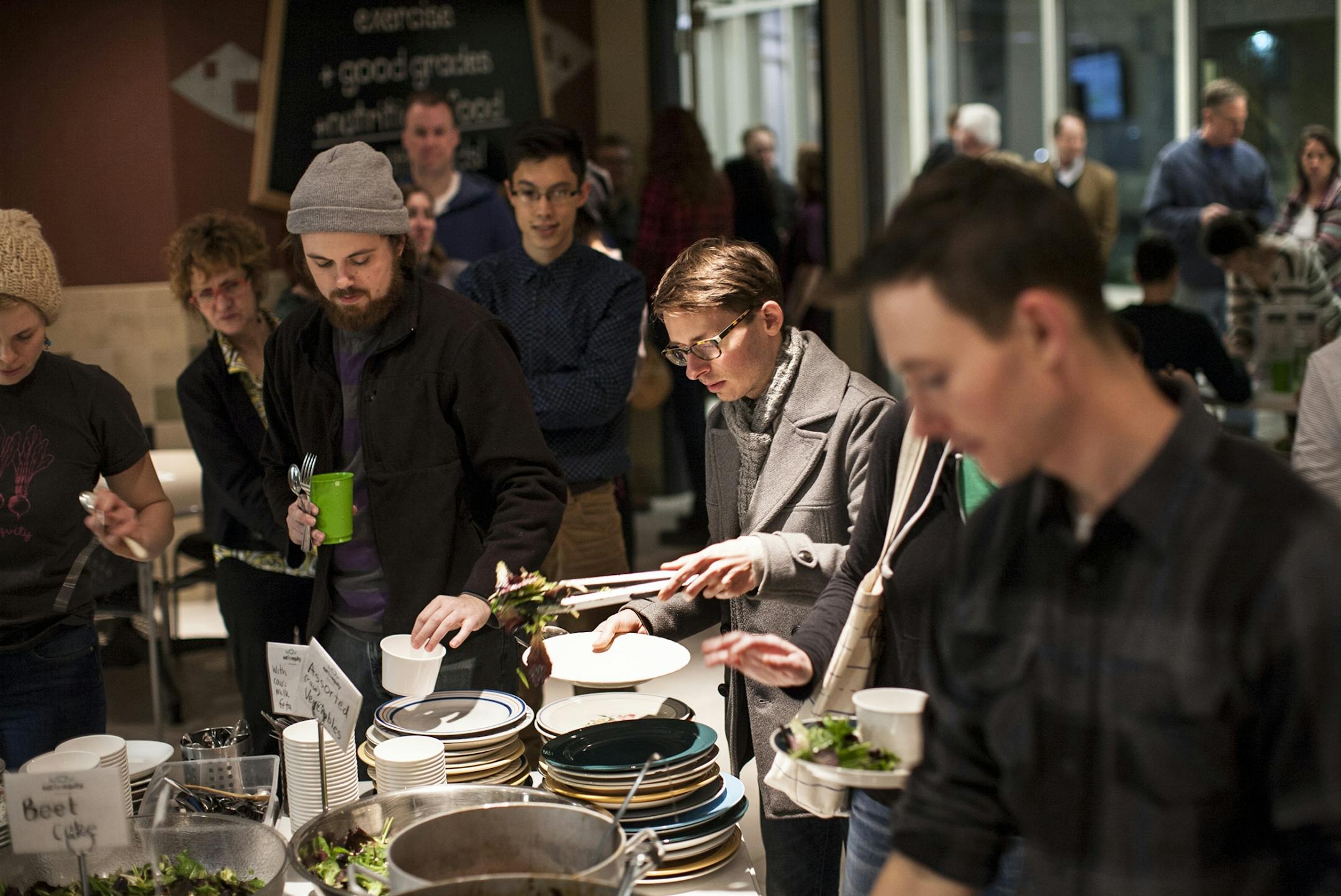 Emily Torgrimson visits with guests at Eat for Equity's community feast benefitting Urban Ventures at the Urban Ventures headquarters in Minneapolis January 31, 2015.