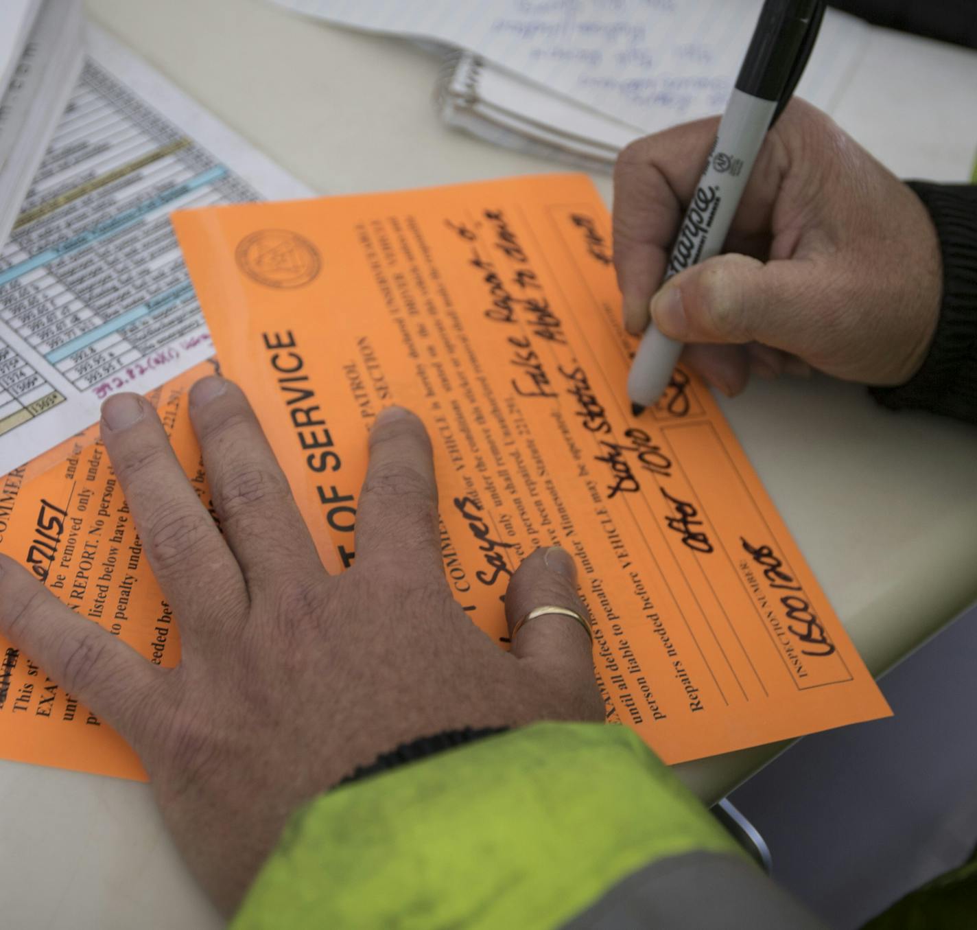 Commercial vehicle inspector Tammy Hafferman wrote out a violation to a truck that didn't have an accurate log record as well as some small visible violations at the St. Croix weigh station on Monday, March 23, 2015, in Stillwater, Minn. ] RENEE JONES SCHNEIDER &#x2022; reneejones@startribune.com