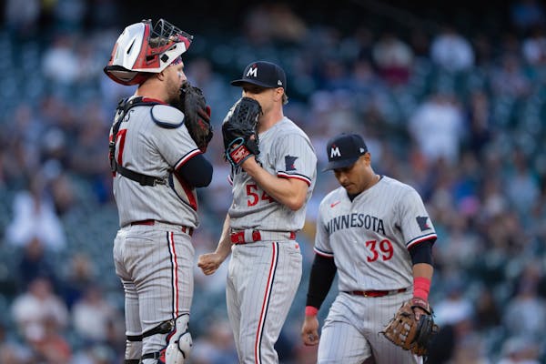 Minnesota Twins starting pitcher Sonny Gray, center, meets at the mound with third baseman Donovan Solano, right, and catcher Ryan Jeffers, left, duri