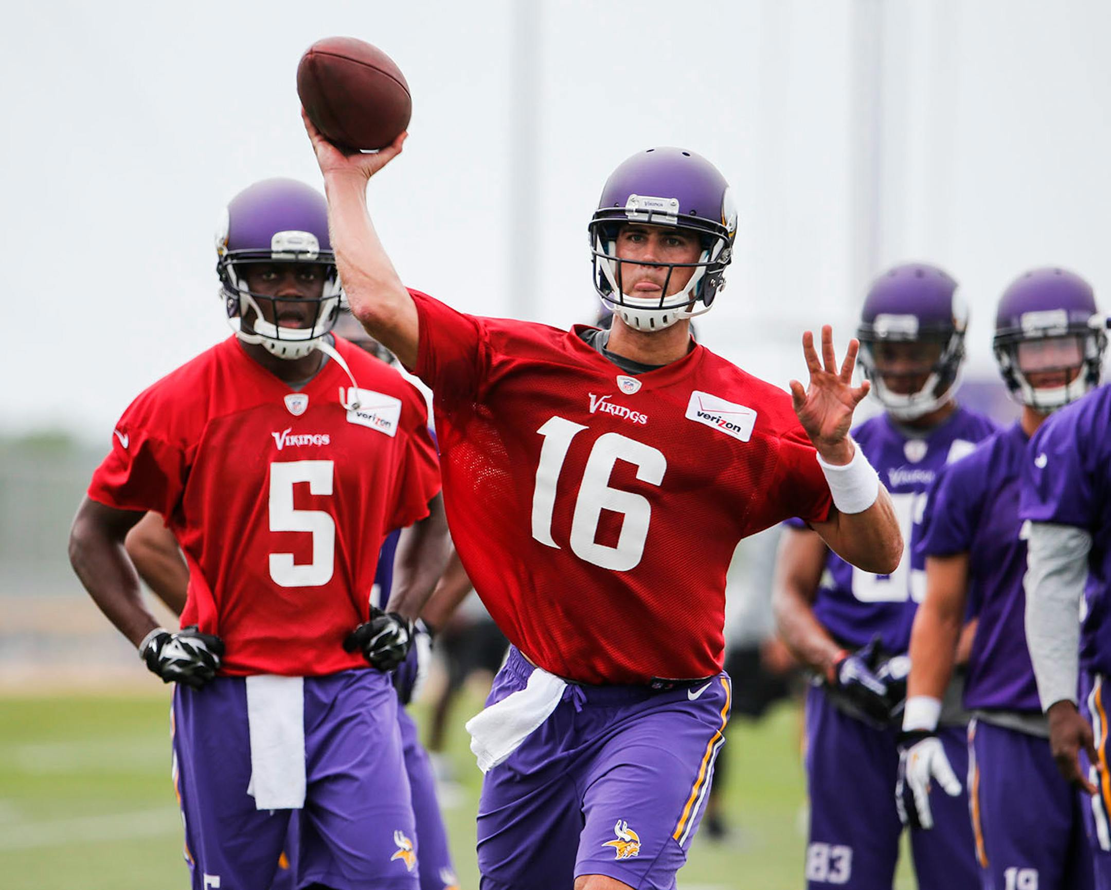 Minnesota Vikings quarterback Matt Cassel (16) fires a pass during drills as rookie quarterback Teddy Bridgewater (5) looks on during training camp Friday, July 24, 2014, at Minnesota State in Mankato, MN.