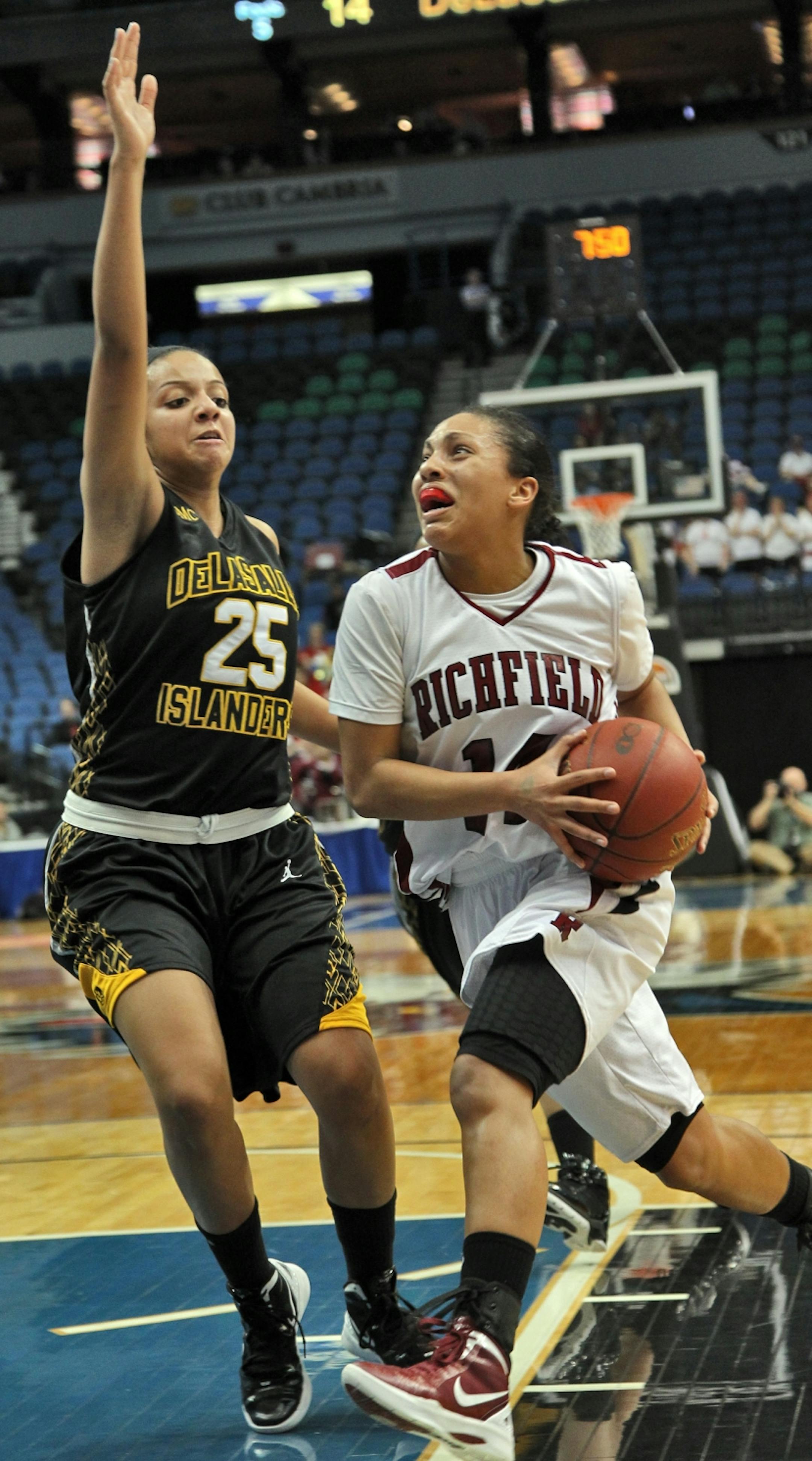 Class 3A Girls Prep Basketball - DeLaSalle vs. Richfield..Richfield's Jessica January, right, drove to the basket against DeLaSalle's Mariah Adanene (25).