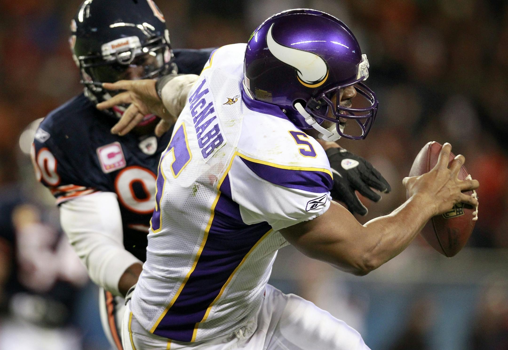 Vikings quarterback Donovan McNabb (5) was sacked by Julius Peppers.