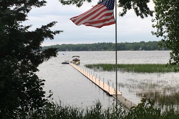 The north side of White Bear Lake, showing water beneath a dock that was extended far out onto the lake when it was at its lower stage.