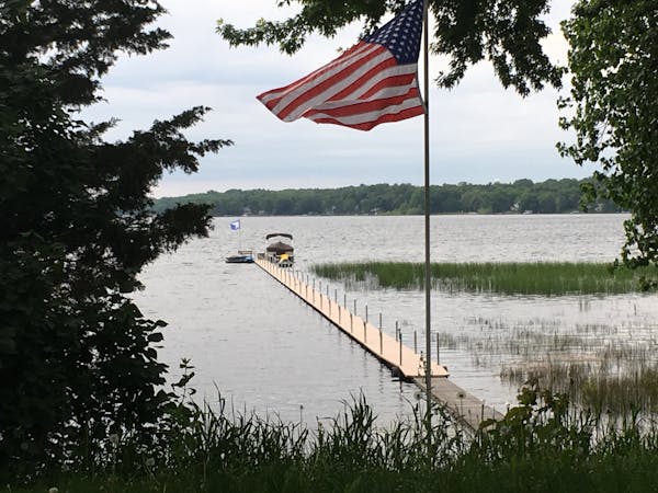 The north side of White Bear Lake, showing water beneath a dock that was extended far out onto the lake when it was at its lower stage.