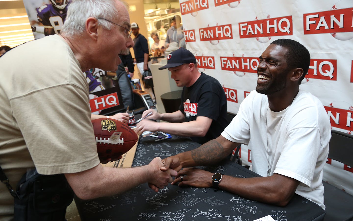 John Staral, of Woodbury joked around with former Viking Randy Moss telling him he agreed with a food review he had. ] (KYNDELL HARKNESS/STAR TRIBUNE) kyndell.harkness@startribune.com Former Minnesota Viking Randy Moss and Tyrone Cater signed autographs at the Ridgedale Mall in Minnetonka Min., Saturday, May 23, 2015. Ticket purchases benefit Tyrone Carter&#xed;s TC Elite Training School and will allow financially challenged Minnesota athletes the opportunity to attend Carter&#xed;s intensive fo