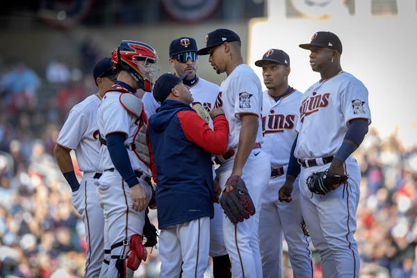 Twins pitching coach Wes Johnson (47) talks to Twins relief pitcher Jhoan Duran (59) on the mound during the top of the sixth inning on opening day at