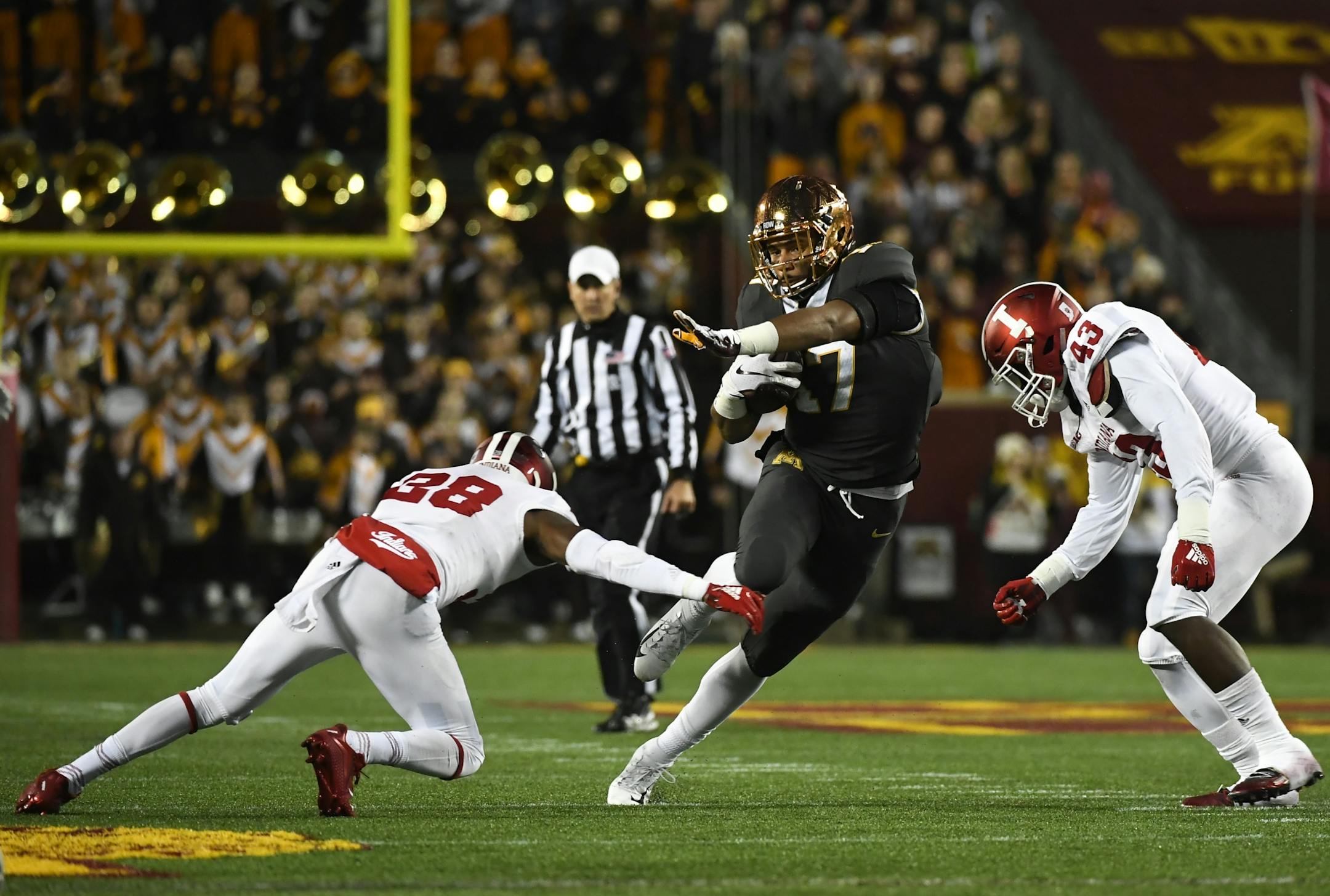 Minnesota Golden Gophers wide receiver Seth Green (17) juked past the defense of Indiana Hoosiers defensive back Jeremy Boyd (38) and linebacker Dameon Willis Jr. (43) in the first quarter.
