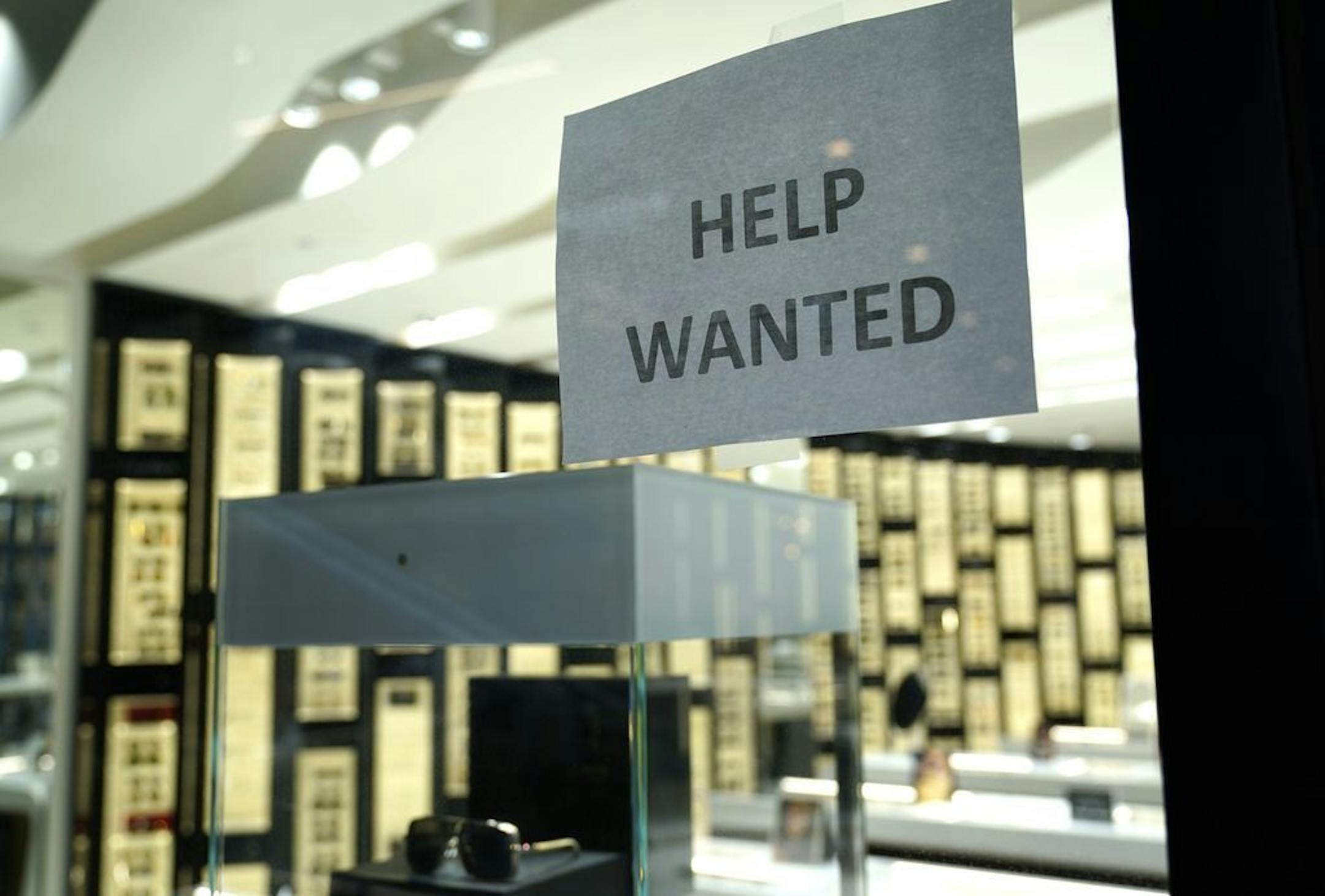 A "help wanted" sign at a Designer Eyes store at Brickell City Centre, Friday, Nov. 6, 2020, in Miami.