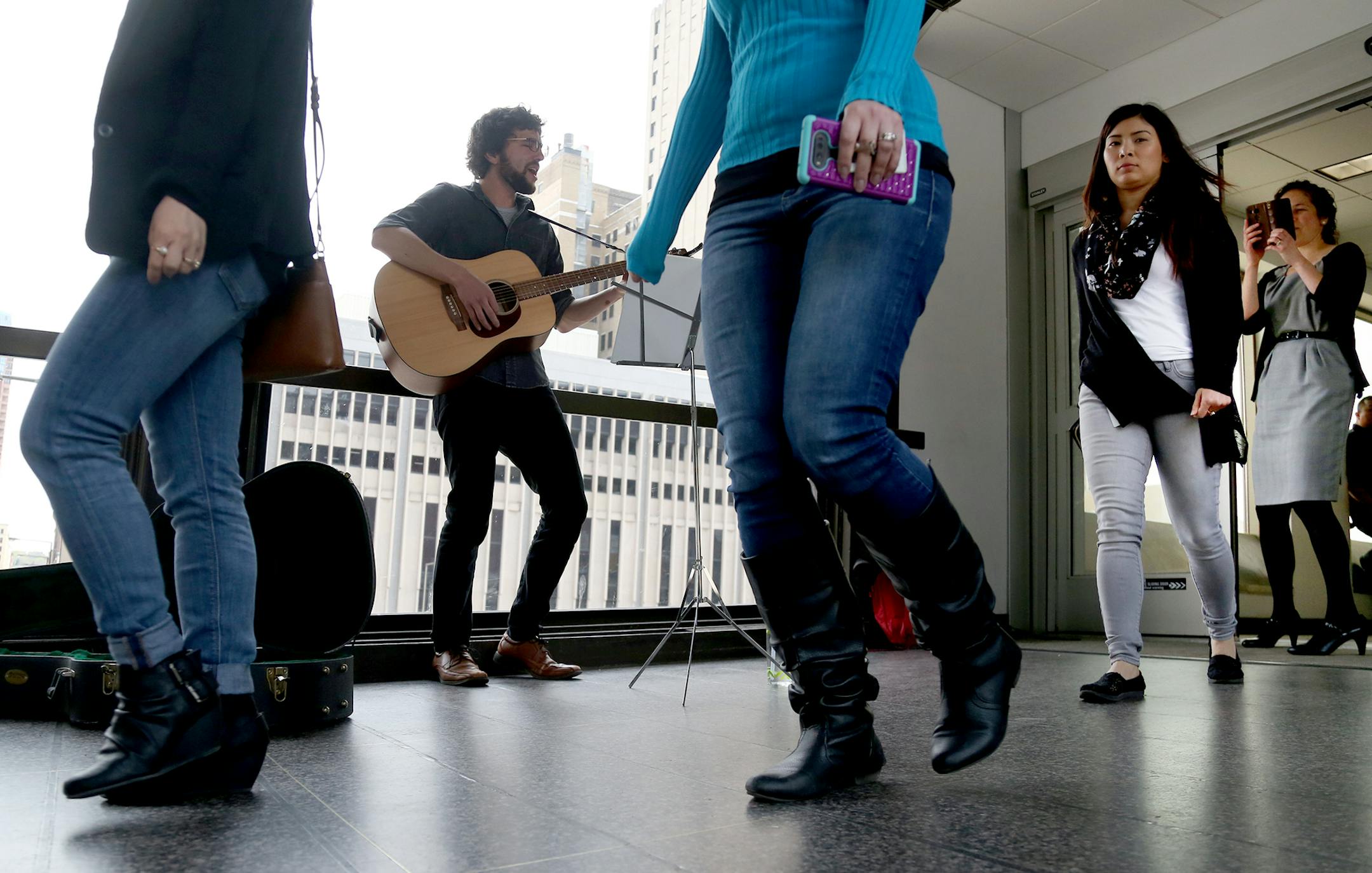 Local musician Ross Hackenmiller gave the first in a series of free concerts in the skyway above the Green Line's Central Station in downtown St. Paul Wednesday, May 3, 2017, in St. Paul, MN. The Wednesday concerts will be paired with donut offerings in the skyway on Monday and Friday mornings through May. "My name is Ross and I like to play guitar," he told a group passing in the skyway, adding that he was also a member of the local band Filthy Animals.] DAVID JOLES ï david.joles@startribu
