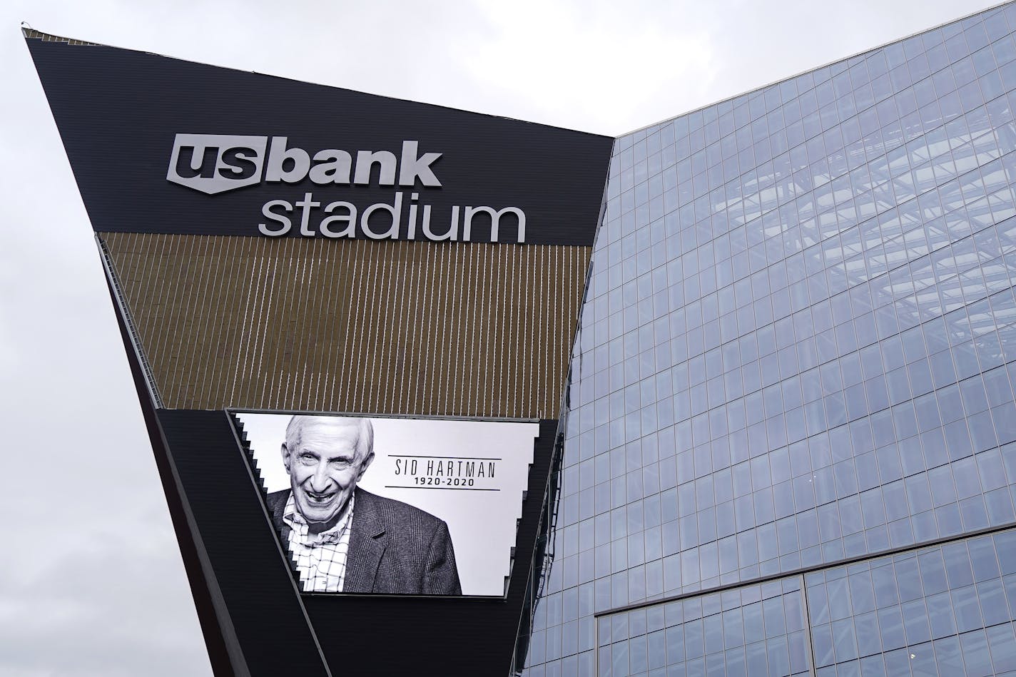 An image of longtime Star Tribune sports columnist Sid Hartman was projected on the video screen outside U.S. Bank Stadium noting his death Sunday