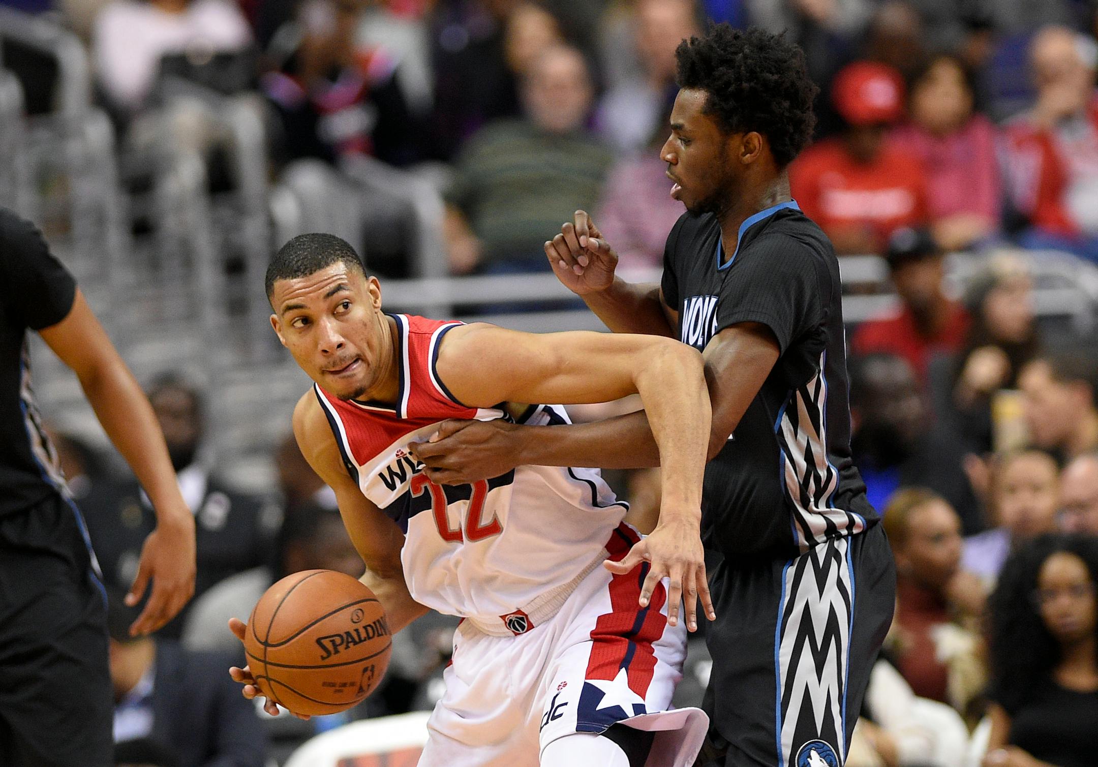 Washington Wizards forward Otto Porter Jr., left, dribbles against Minnesota Timberwolves forward Andrew Wiggins, right, during the first half of an NBA basketball game, Friday, Jan. 6, 2017, in Washington. (AP Photo/Nick Wass)
