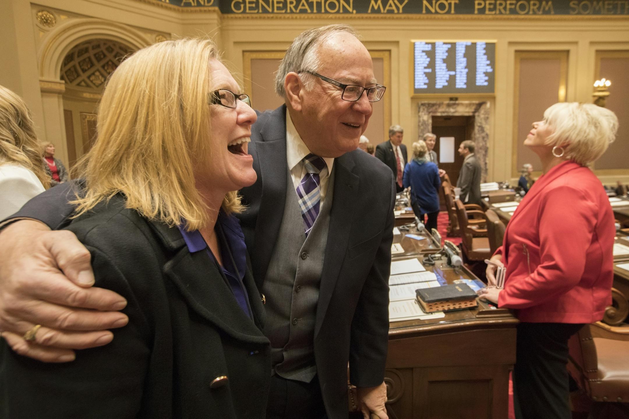 Sen. Michelle Fischbach, left, and Sen. David Senjam, R-Rochester, greet each other before the session in the Minnesota Senate chambers.