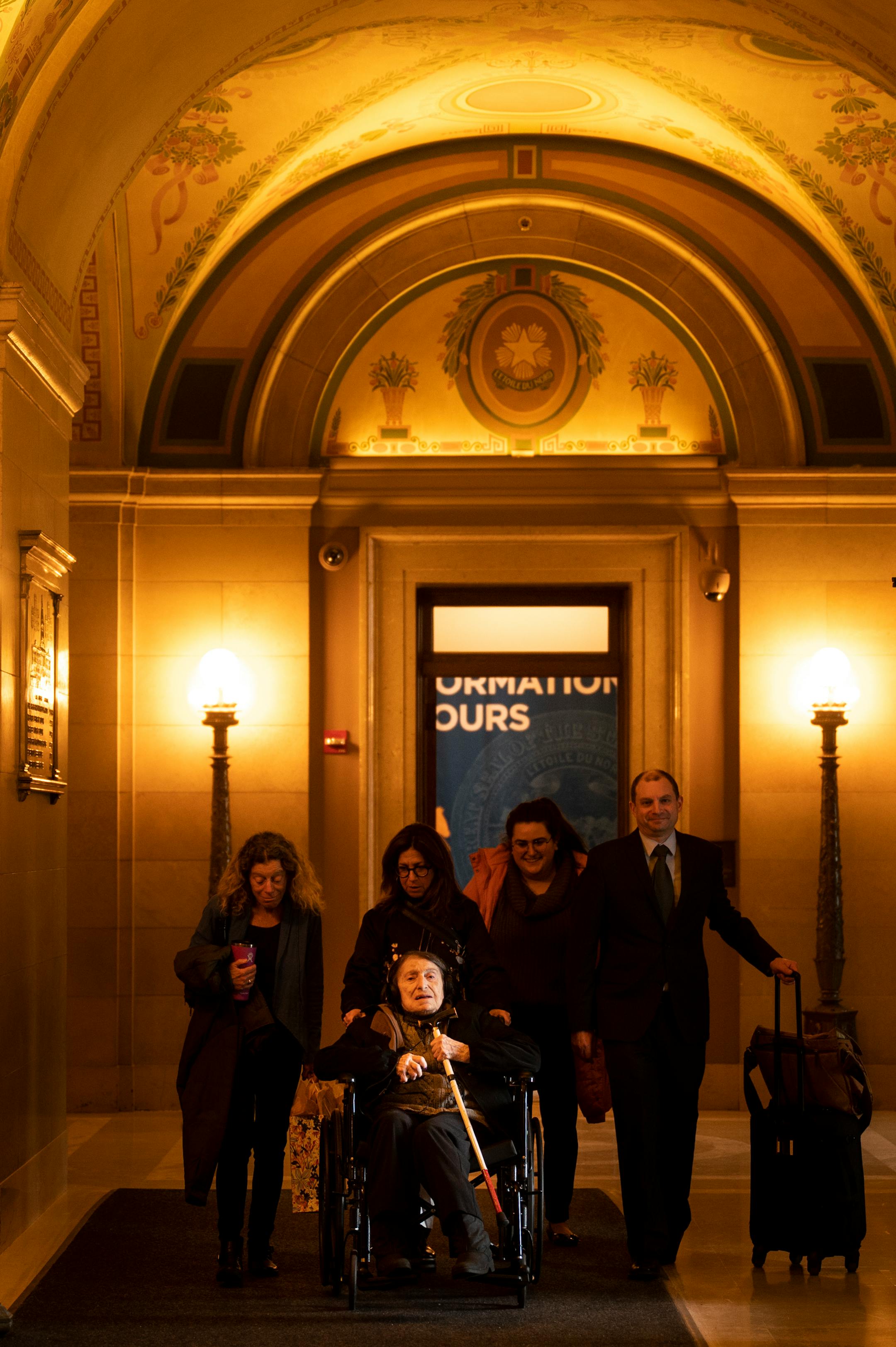 Dora Zaidenweber, bottom center, was escorted through the capitol by her daughter, Rosanne, far left, and members of the Jewish Community Relations Council after Zaidenweber testified to the Minnesota House Education Policy Committee.
