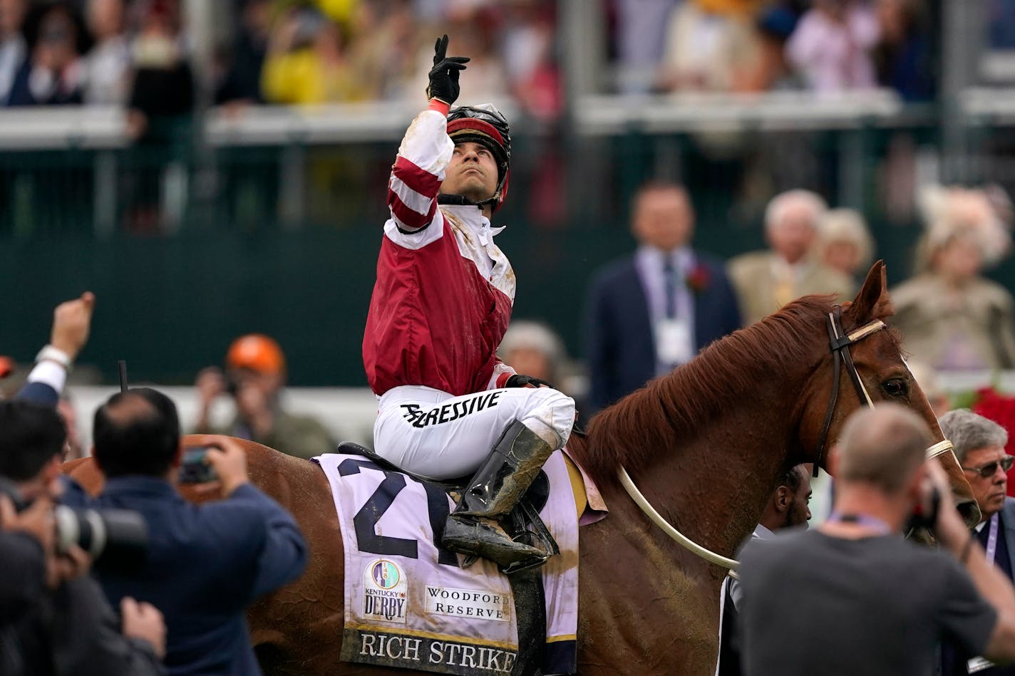 Sonny Leon, riding Rich Strike, celebrates after winning the 148th running of the Kentucky Derby