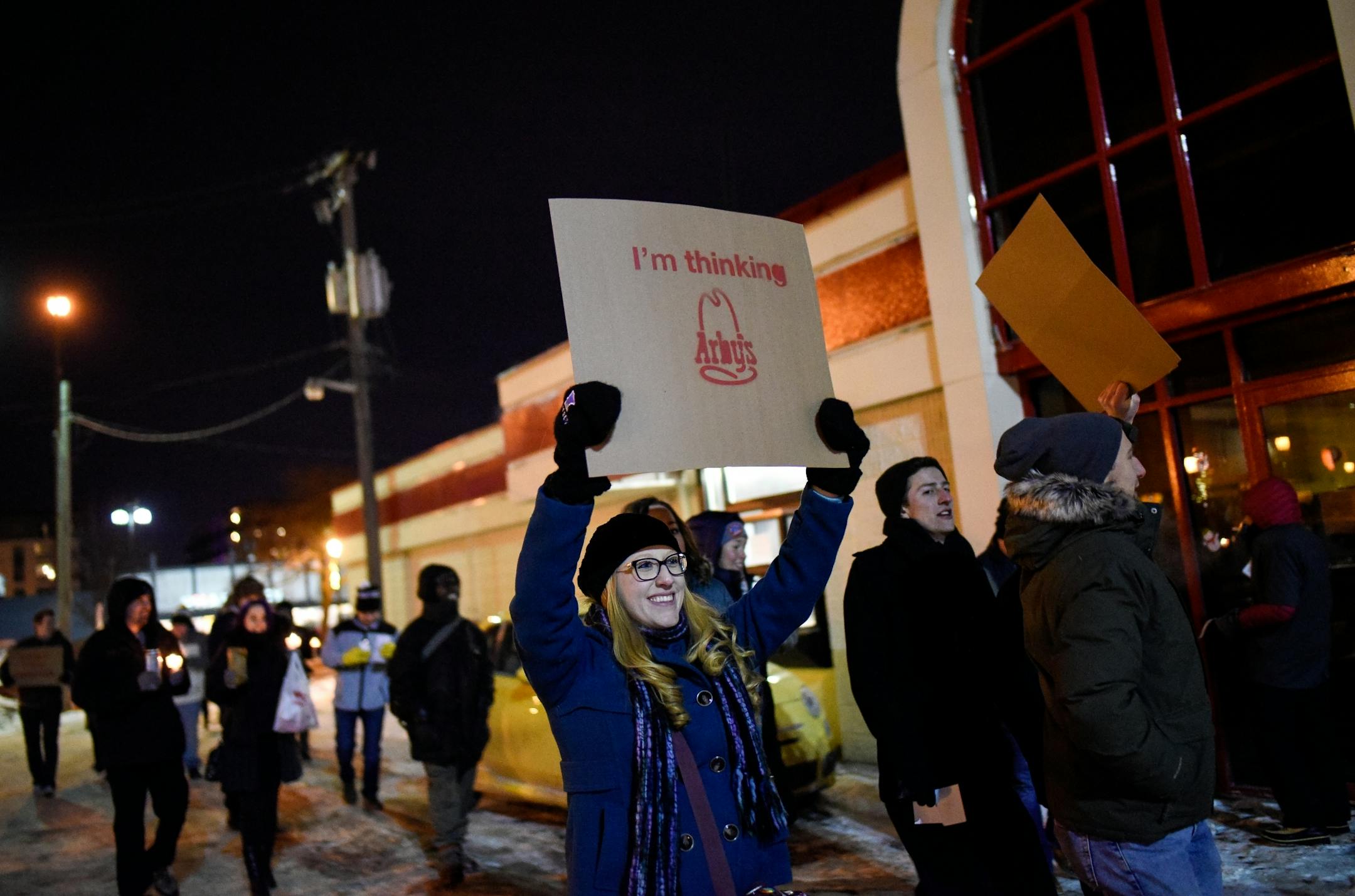 Heather Milovac, of St. Paul, took part in a procession that marched through the now-closed Uptown Arby's drive through during Friday night's vigil.
