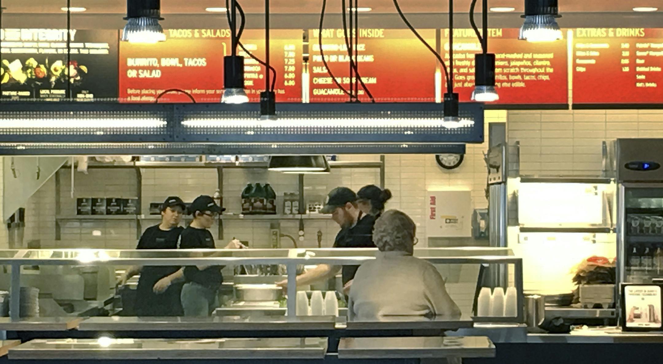 Workers prepare food at a Chipotle store Thursday, March 10, 2016, in Billerica, Mass., in advance of reopening later in the day. The store was closed Wednesday amid concerns some employees had contracted the norovirus. None of the sick employees came in to work, but the store was closed and cleaned as a precautionary measure. (AP Photo/Rodrique Ngowi)