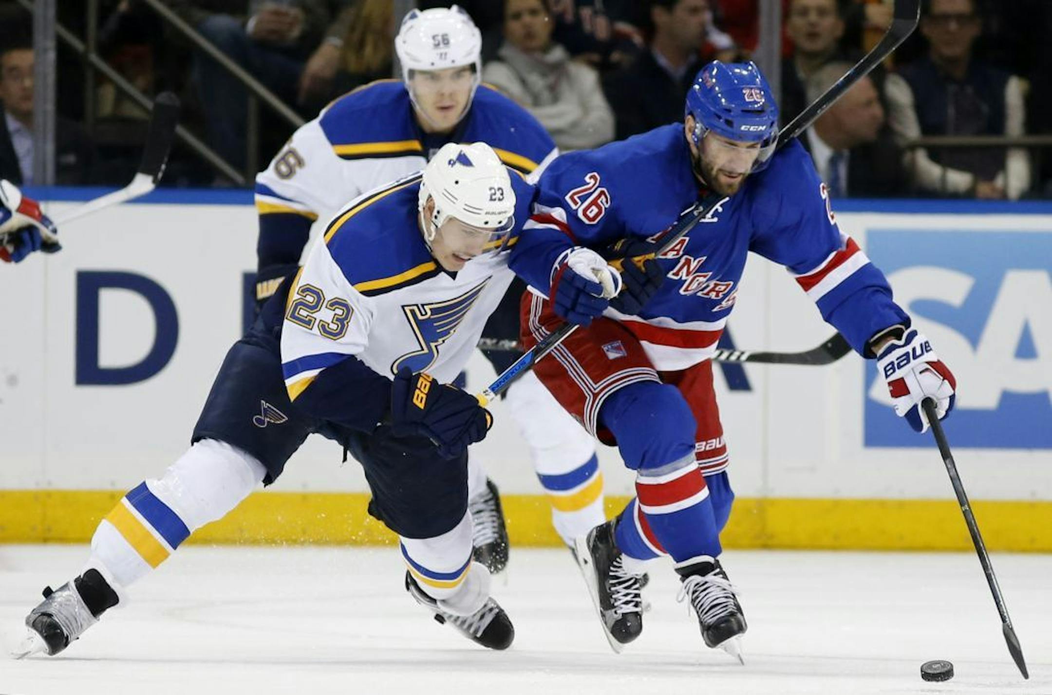 Blues right wing Dmitrij Jaskin (23) defends against Jarret Stoll (right) last month. Stoll was picked up off waivers by the Wild on Tuesday.