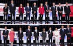 In a two-photo combination, candidates take the stage before the start of the Democratic presidential debates hosted by CNN at the Fox Theatre in Detr