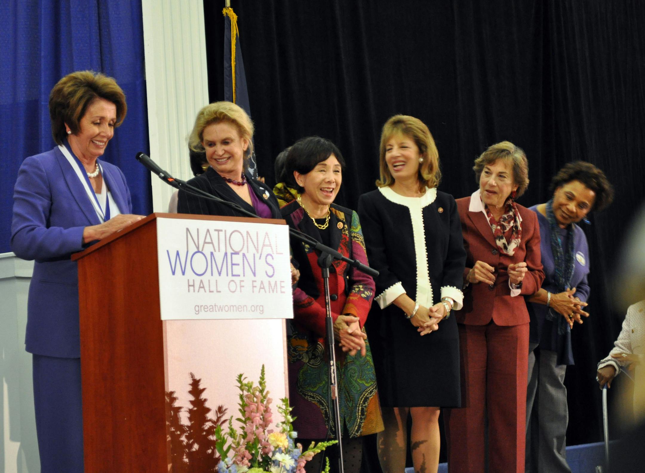 Nancy Pelosi invites fellow congresswomen onto the stage during her acceptance speech during the induction ceremony for the National Womenís Hall of Fame Saturday Oct. 12, 2013 at the New York Chiropractic College Athletic Center in Seneca Falls, N.Y. (AP Photo/Finger Lakes Times, Susan Clark Porter)
