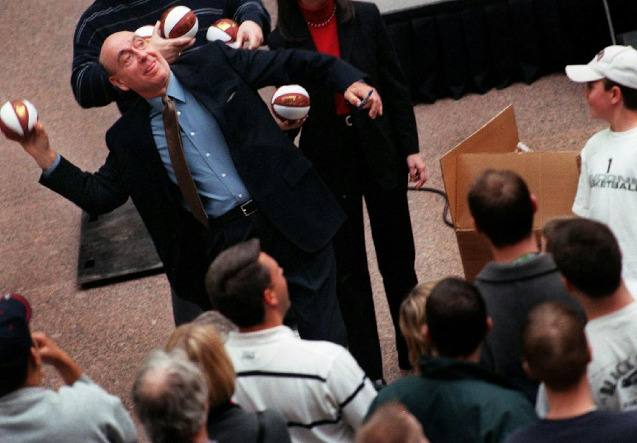 Dick Vitale tosses a souvenir ball to a fan on the balcony at the Crystal Court in downtown Minneapolis in 2006.
