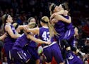 Goodhue players celebrate their 73-51 win over Mountain Iron-Buhl during the girls' basketball state tournament, Class 1A championship with Saturday, 