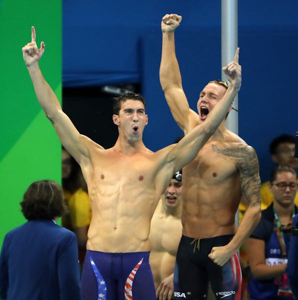 Michael Phelps celebrates their gold medal victory in the men's 1x400 freestyle relay.