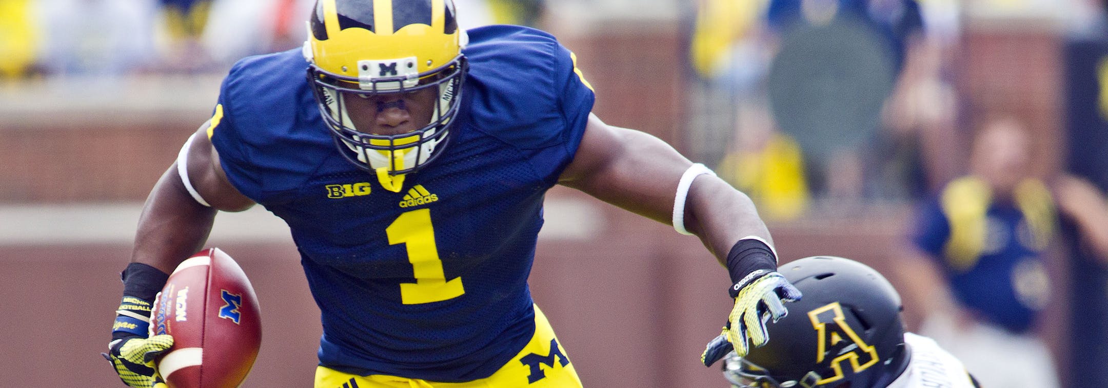 Michigan wide receiver Devin Funchess (1) breaks away from Appalachian State defensive back A.J. Howard, bottom, in the first quarter of an NCAA college football game in Ann Arbor, Mich., Saturday, Aug. 30, 2014. (AP Photo/Tony Ding) ORG XMIT: MITD104