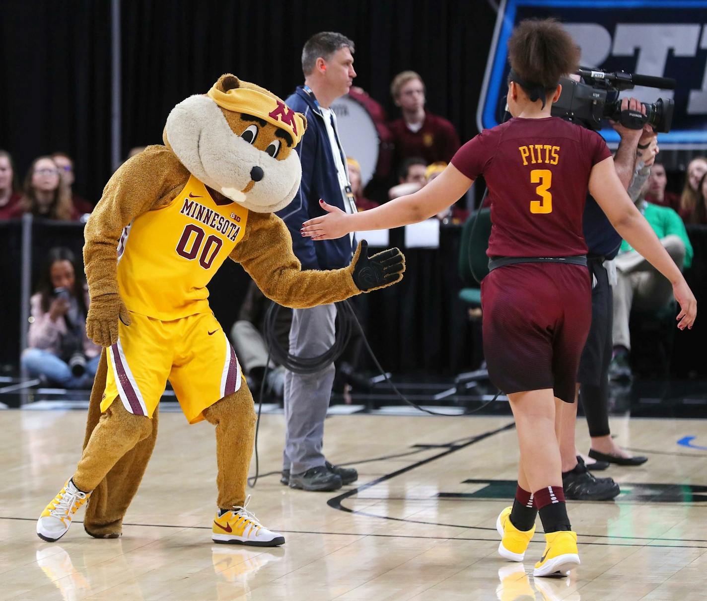 The Minnesota mascot slaps hands with Minnesota Golden Gophers guard/forward Destiny Pitts (3) during player introductions in the 2018 Big Ten Women's Basketball Tournament held at Bankers Life Fieldhouse in Indianapolis, IN on Saturday, March 3, 2018.