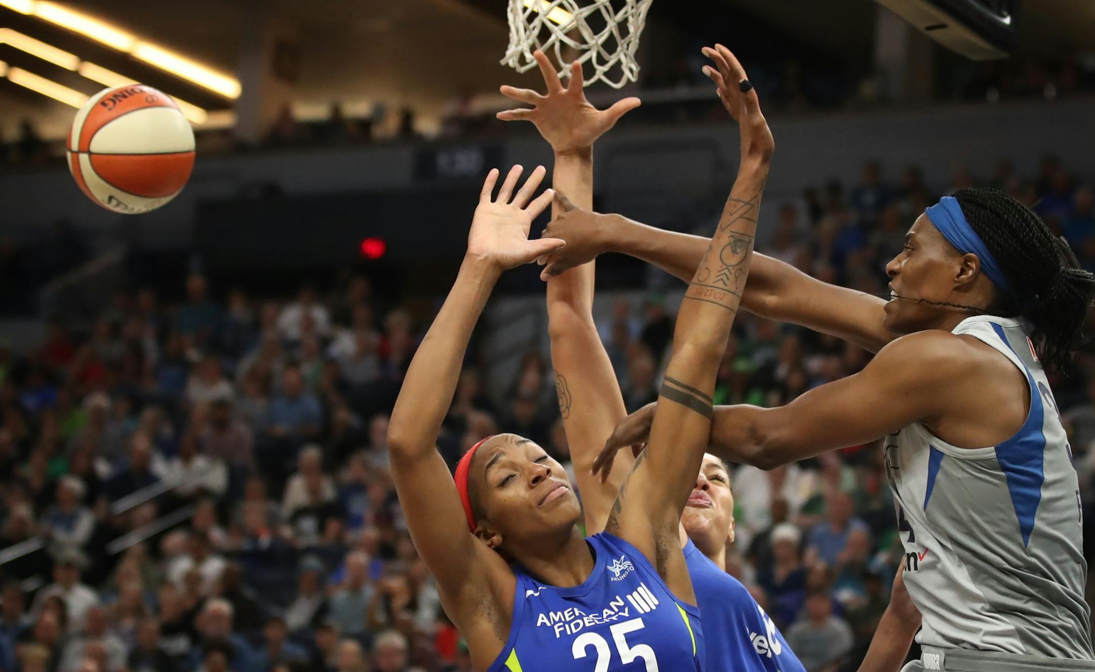 Lynx Sylvia Fowles passed the ball pass Wings Glory Jonson (25) and Liz Cambage at Target Center Tuesday , June 19, 2018 in Minneapolis, MN.