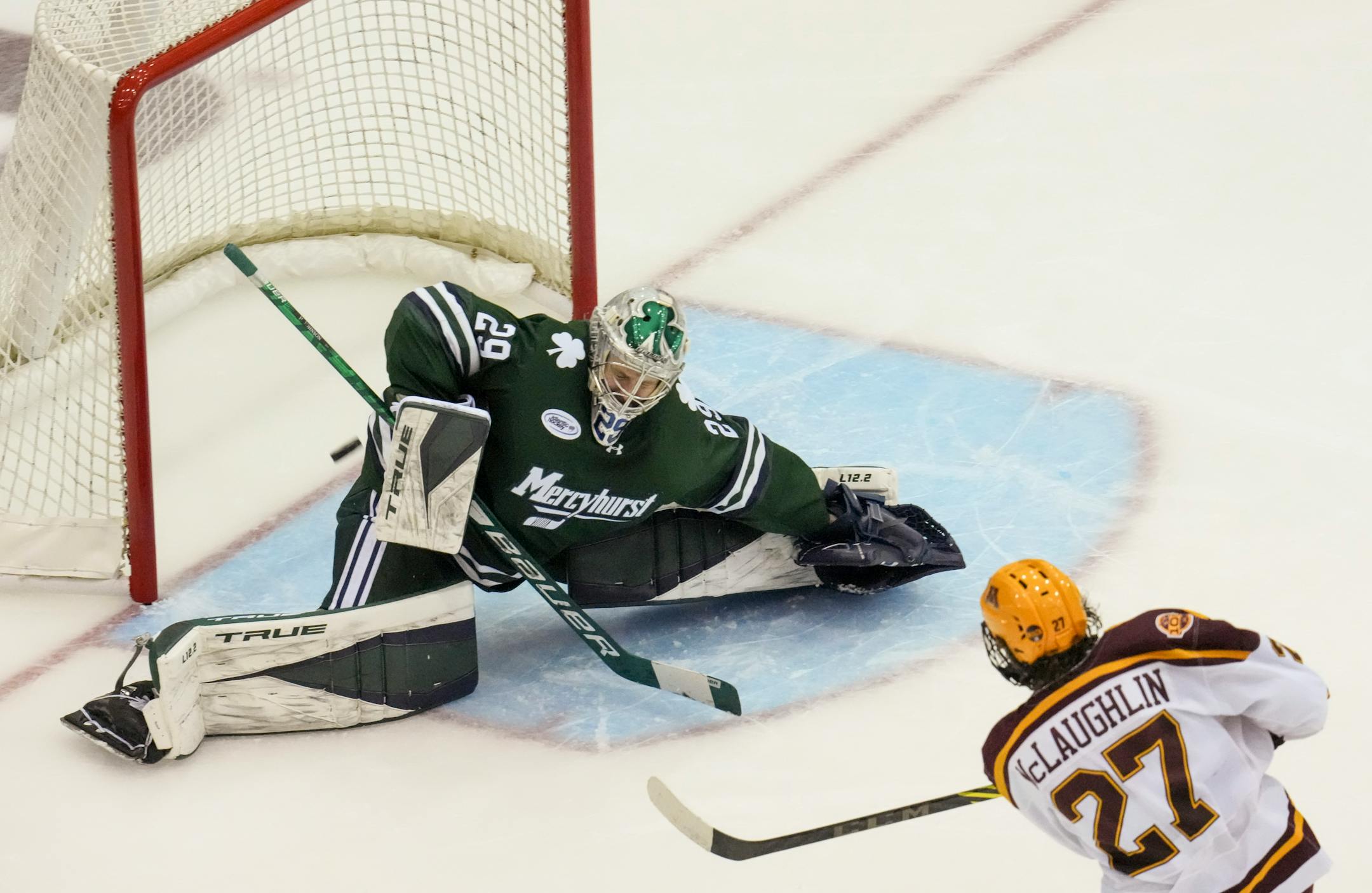 Minnesota forward Blake McLaughlin (27) got the puck past Mercyhurst goaltender Hank Johnson (29) in the third period.
