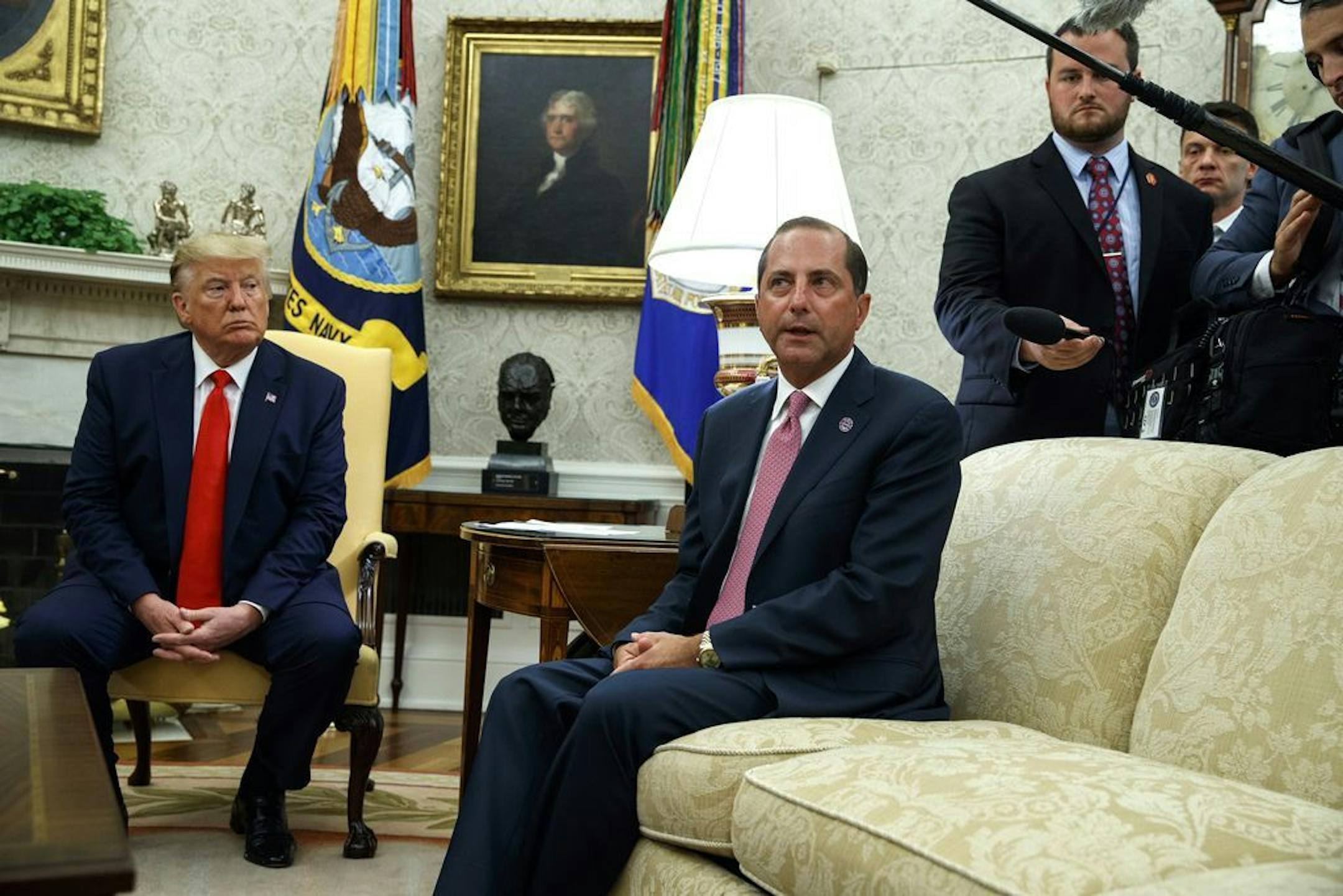 President Donald Trump listens as Secretary of Health and Human Services Alex Azar talks about a plan to ban most flavored e-cigarettes, in the Oval Office of the White House, Wednesday, Sept. 11, 2019, in Washington.