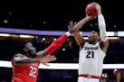 Gonzaga forward Rui Hachimura, right, shoots over Texas Tech center Norense Odiase during the first half of the West Regional final in the NCAA men's 