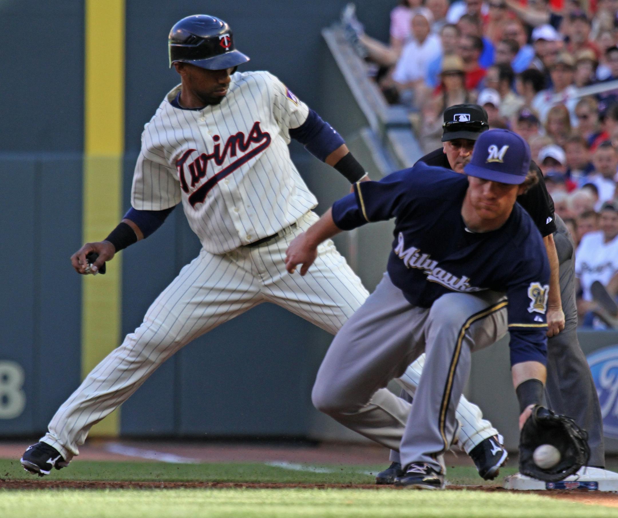(left to right) Minnesota Twins vs. Milwaukee Brewers. Twins Alexi Casilla got back to first safe as Brewers Mat Gamel took the throw from pitcher Chris Narveson in first inning action, Saturday, 7/2/2011.