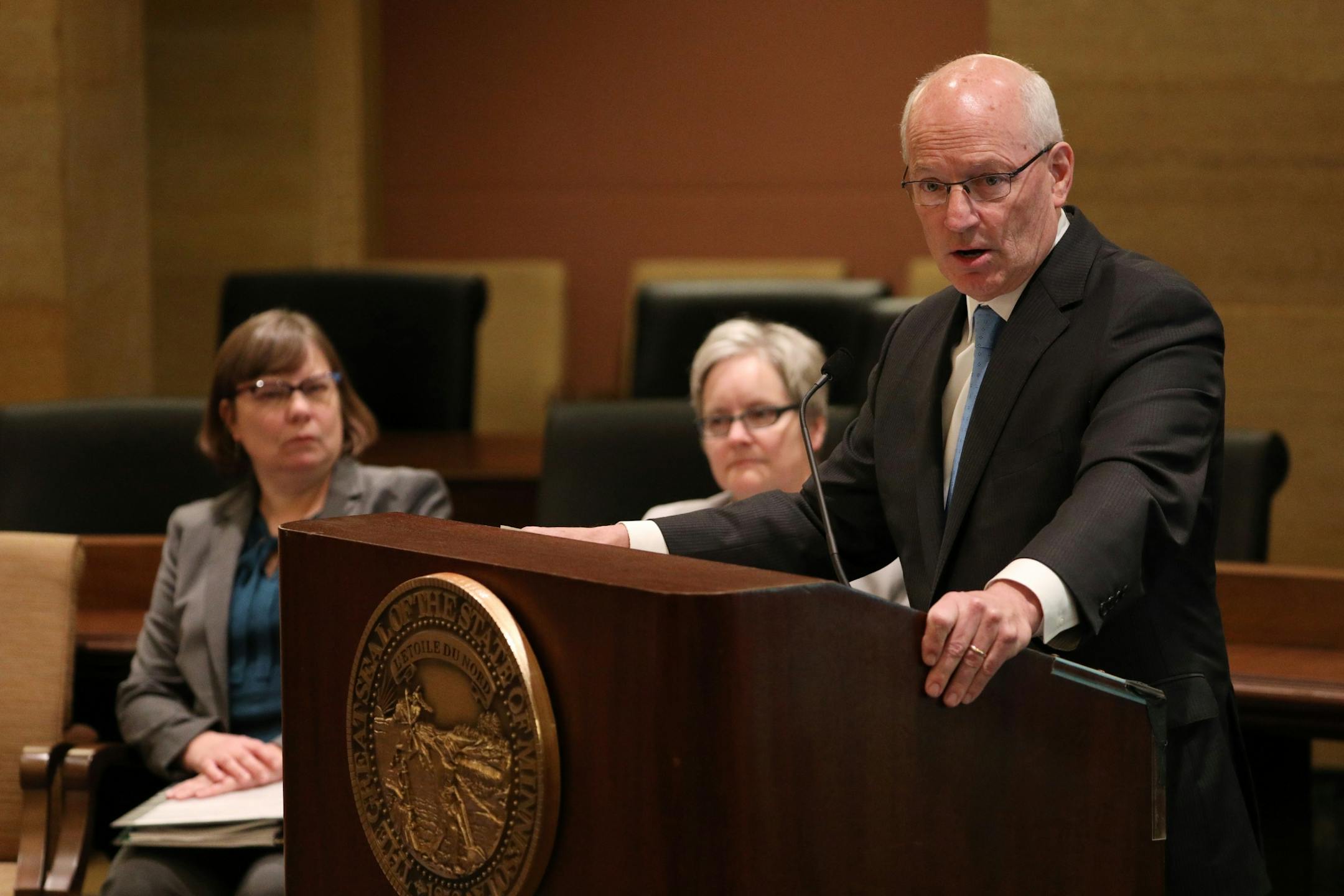 Myron Frans, commissioner of Minnesota Management and Budget , spoke during the budget forecast as state economist Laura Kalambokidis, left and state budget director Margaret Kelly, right, looked on Tuesday.
