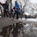 Young skiers dodged a puddle as they carried their gear to the parking lot.