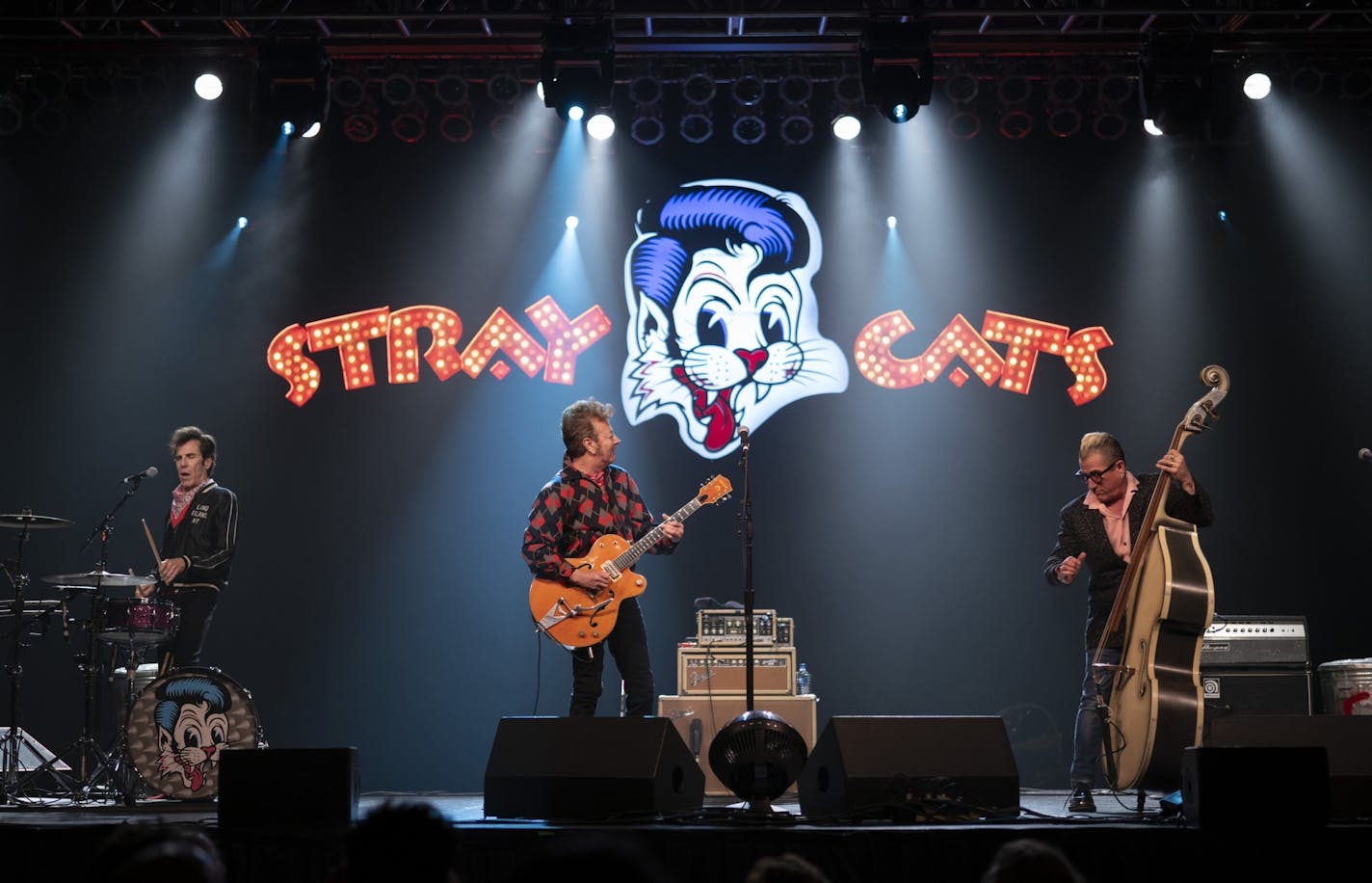 Brian Setzer with drummer Slim Jim Phantom and bassist Lee Rocker of the Stray Cats early in their performance Sunday night at the Island Event Center in Welch.