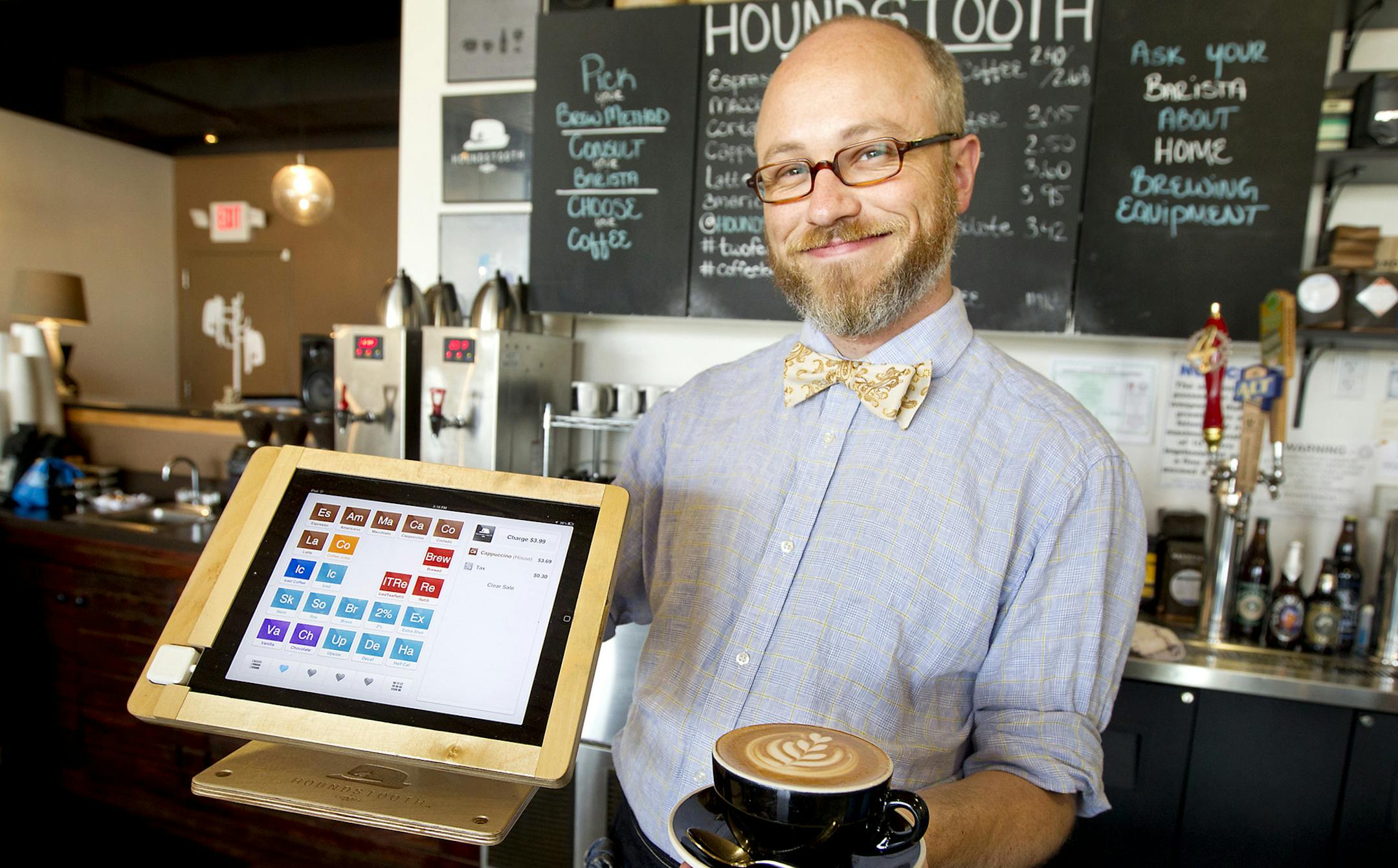Barista Rudi Miller poses for portrait March 23, 2013, at Houndstooth Coffee in Austin, Texas, which is one of several area retailers using the Square mobile payments technology. The shop uses a swivel mounted iPad for its point-of-sale device and swivels it over to customers so they can sign for credit card purchases. (Laura Skelding/Austin American-Statesman/MCT)