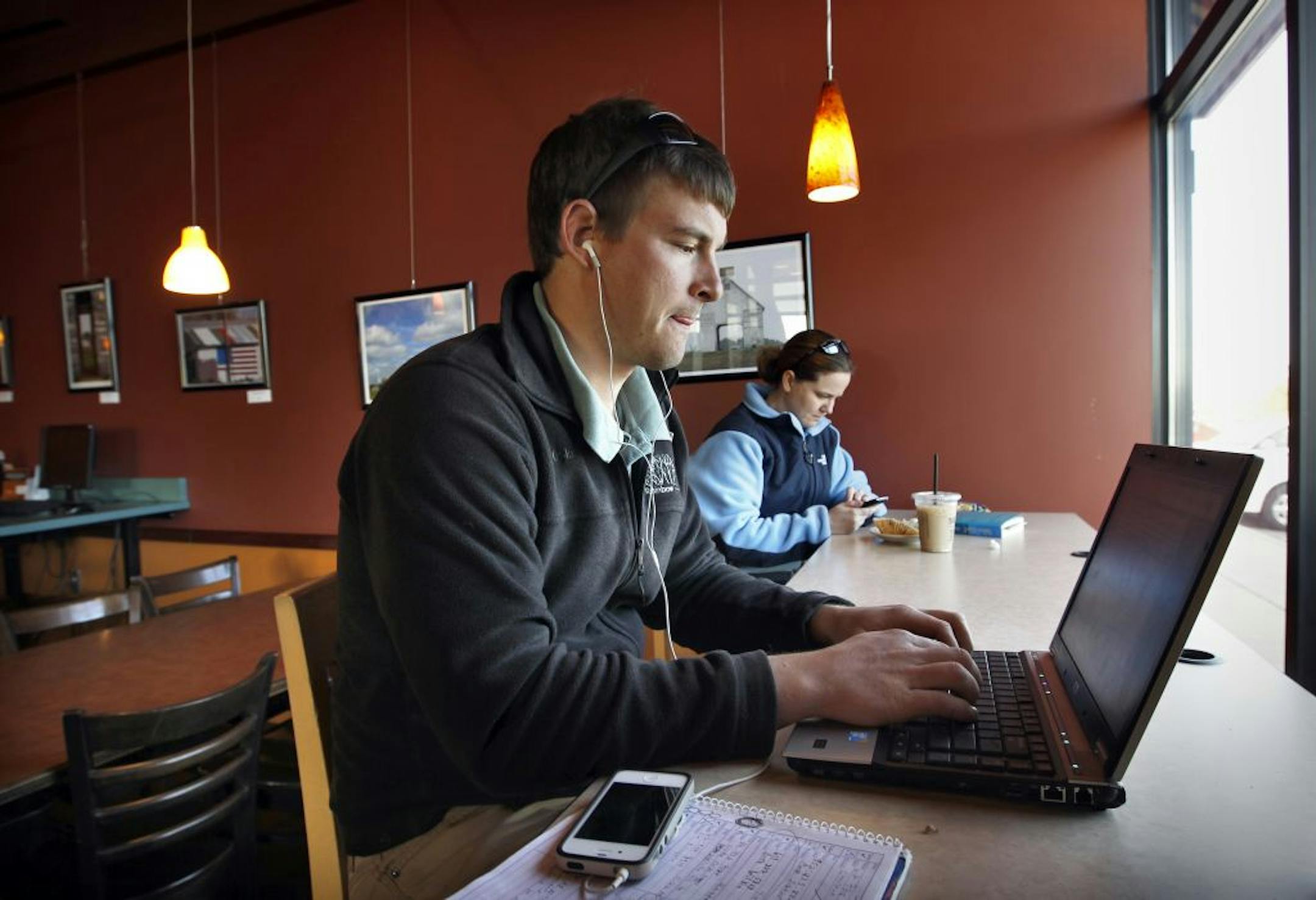 At Dunn Bros. in Eagan, Sterling Malcomson sat at a countertop that runs across the front window, ­typical of the company's design approach in accommodating laptop users.