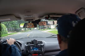 Dale Robinson, who owns Ken's Driving School, teaches a behind the wheel lesson in Columbia Heights on Friday, June 28. Minnesotans are dealing with l