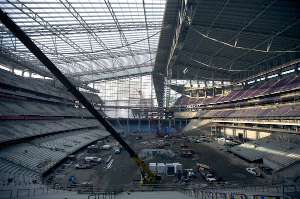 Three layers of slick, translucent plastic and two air pillows stretch over the steel roof supports of the new Vikings stadium.
