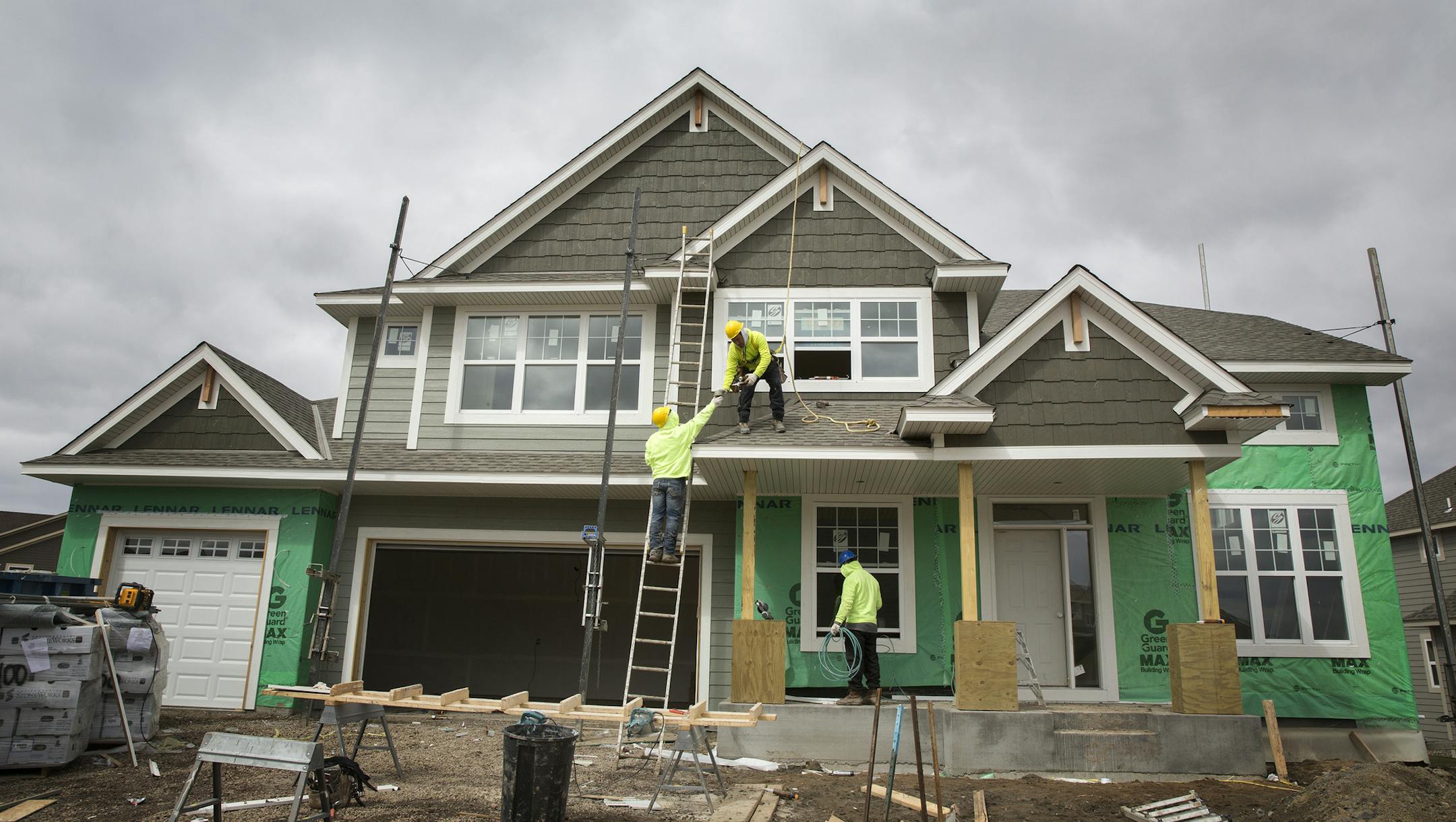 Construction workers build a home in the new Lennar Homes development called The Reserve at Spring Meadows in Plymouth on Thursday, March 26, 2015. ] LEILA NAVIDI leila.navidi@startribune.com /