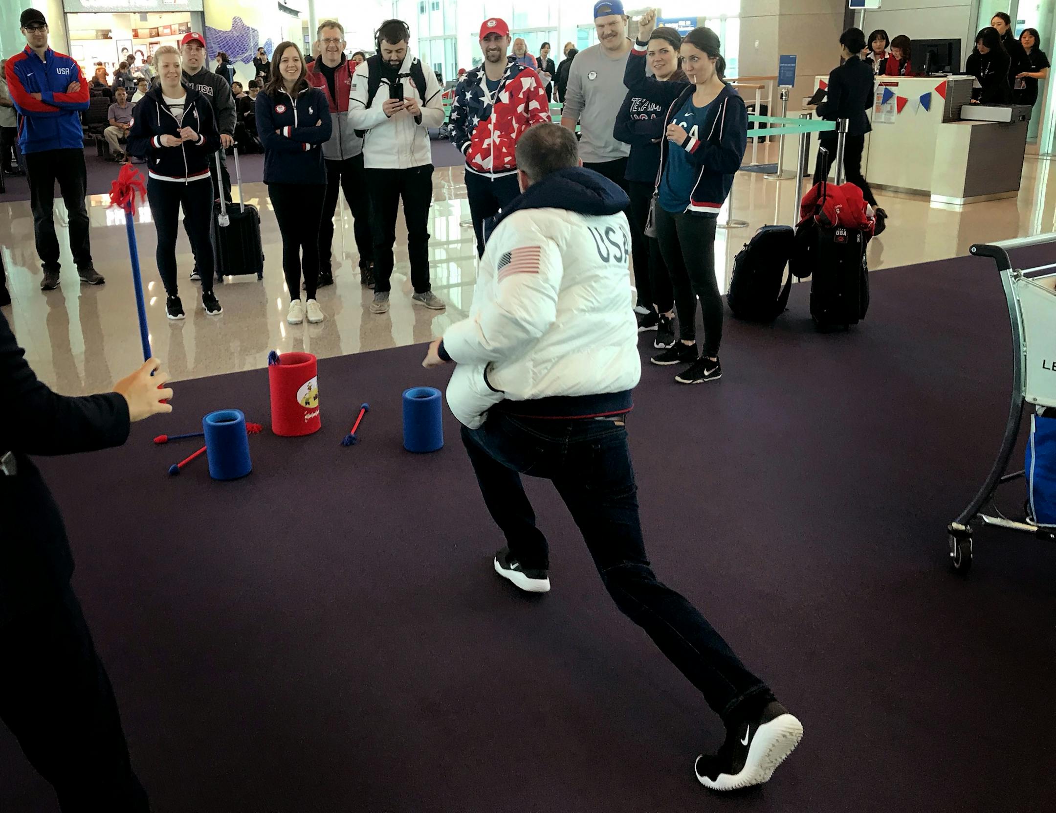 Members of the USA men's and women's curling teams played a game as they waited to board flight home from Incheon Airport South Korea.