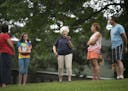 From left, Alyssa Morris and her daughter Hannah Morris, 11, both of Coon Rapids, stand with tour guide Rhea Nyquist, of St. Paul, as she explained in