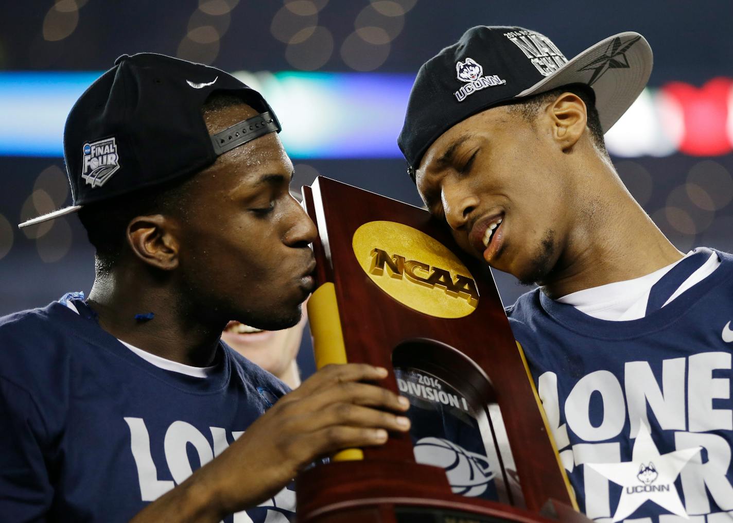 FILE - In this April 7, 2014, file photo, Connecticut guard Terrence Samuel, left, and guard Ryan Boatright hold the championship trophy after beating Kentucky 60-54 at the NCAA Final Four college basketball championship game in Arlington, Texas. After a roller-coaster college career that included NCAA sanctions, a shooting death in his family, and a national championship, the senior guard is expects this will be the year he fulfills many of his own dreams. (AP Photo/David J. Phillip, File)